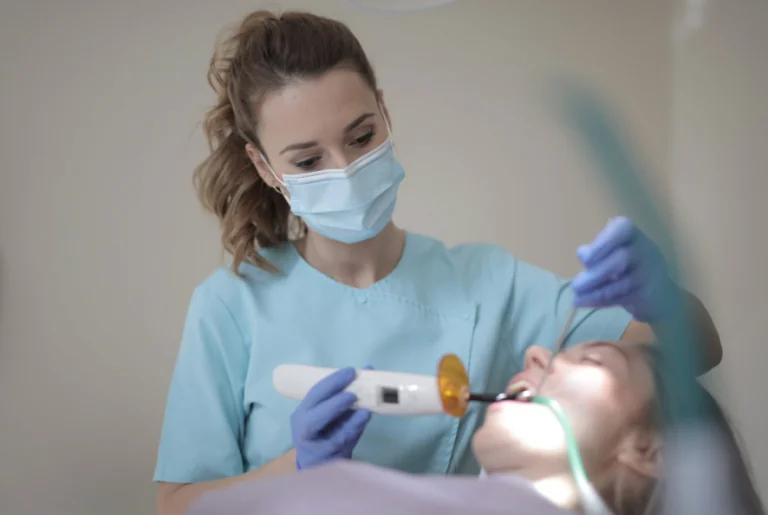 Dentist applying dental bonding material to a patient's tooth